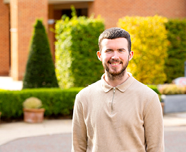 Image of student standing outside smiling.